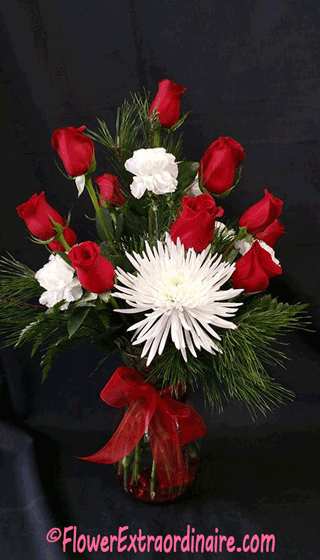 elegant floral arrangement of red roses, white carnations, and evergreen sprigs